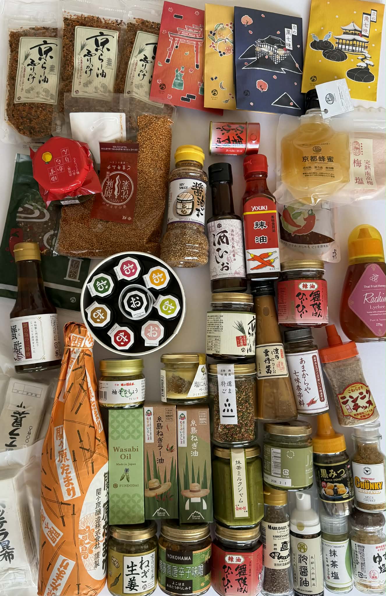 Assorted Japanese food products including bottles, jars, and packets on a white background.